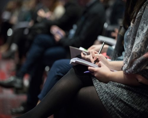 Beginner attendee reviewing event notes